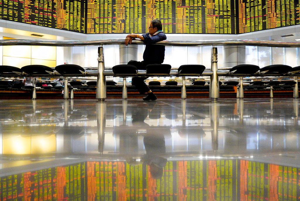 A man sits in front of stock trading boards at a private stock market gallery in Kuala Lumpur in this Dec 13, 2018 file photo. Photo: AP