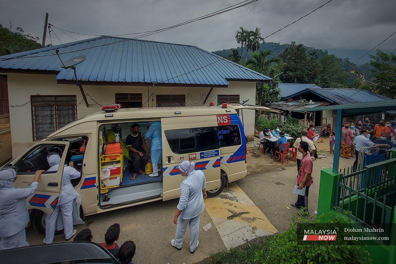 Health workers from a mobile vaccination unit administer doses of Covid-19 vaccine at an Orang Asli village in Sungai Gabai, Hulu Langat in Selangor.