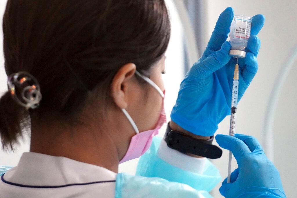 In this June 30 file photo, a health worker prepare a dose of the Moderna Covid-19 vaccine at a ward in Tokyo. Photo: AP
