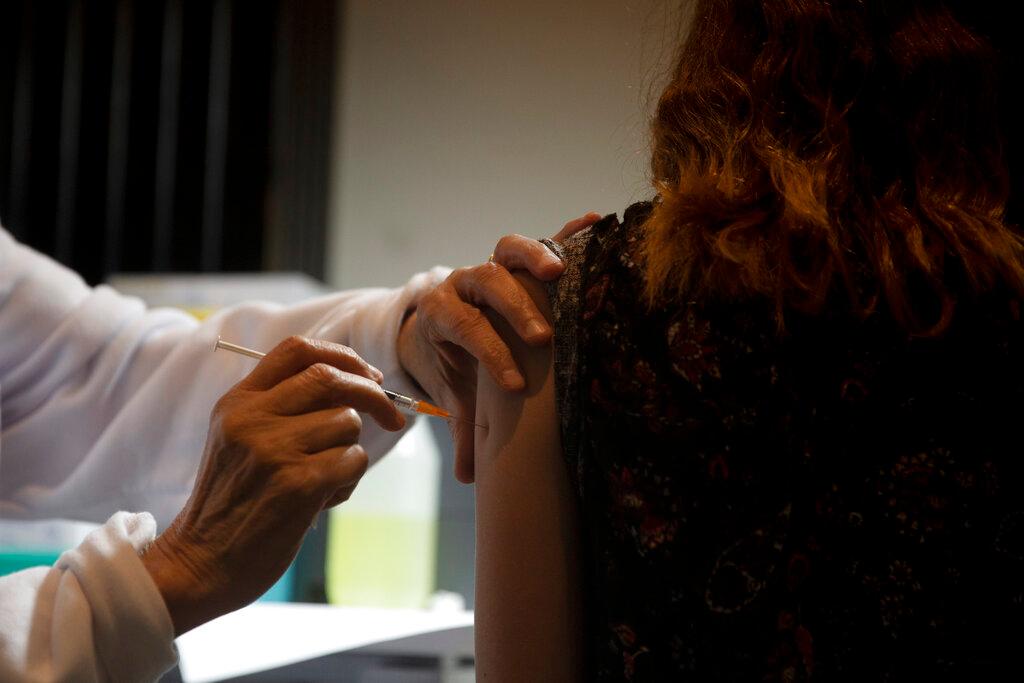 A medical professional administers a booster shot for the coronavirus vaccine at Clalit Health Services, one of Israel's health maintenance organisations, in Jerusalem, Aug 15. Photo: AP
