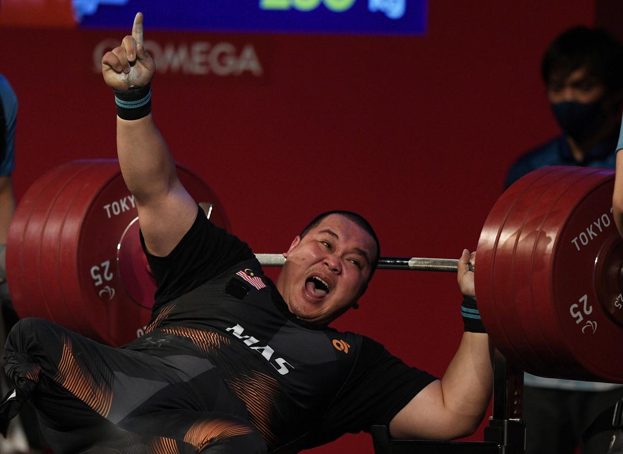 National powerlifting athlete Jong Yee Khie who won silver in the men's 107kg category celebrates at the Tokyo Paralympics. Photo: Bernama