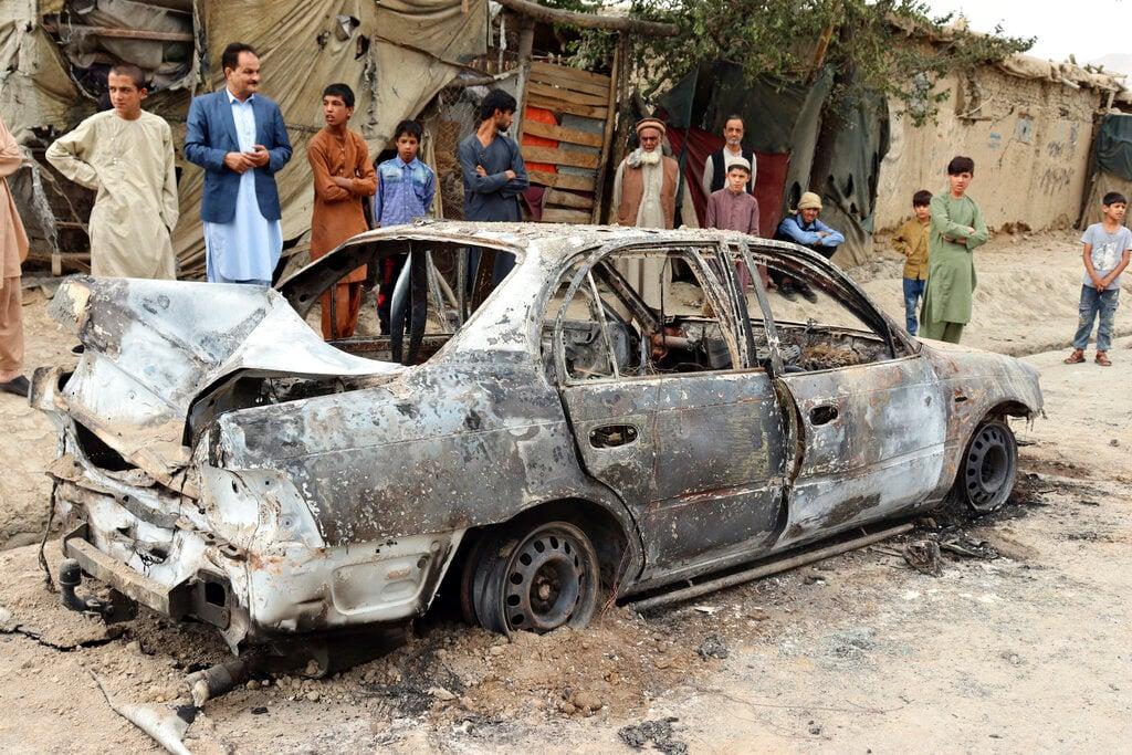 Locals view a vehicle damaged by a rocket attack in Kabul, Afghanistan, Aug 30. Rockets struck a neighbourhood near Kabul's international airport amid the ongoing US withdrawal from Afghanistan. Photo: AP