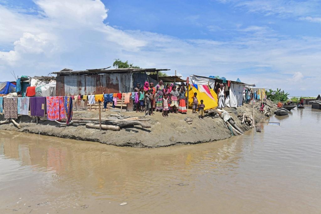 Villagers take shelter on higher ground in a flood-affected area of Morigaon district in India's Assam state on Aug 30. Photo: AFP