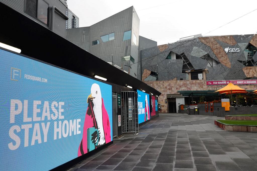 Signage asking people to stay home is seen at Federation Square in downtown Melbourne on Aug 6. Photo: AFP