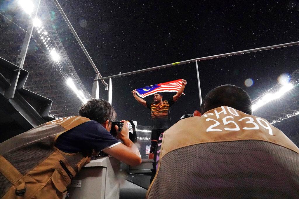 Photographers take pictures as Muhammad Ziyad Zolkefli reacts after competing in the men's shot-put F20 final during the Tokyo 2020 Paralympics Games at the National Stadium in Tokyo, Japan, Aug 31. Ziyad appeared to have won gold but was disqualified for showing up late for the competition. Photo: AP