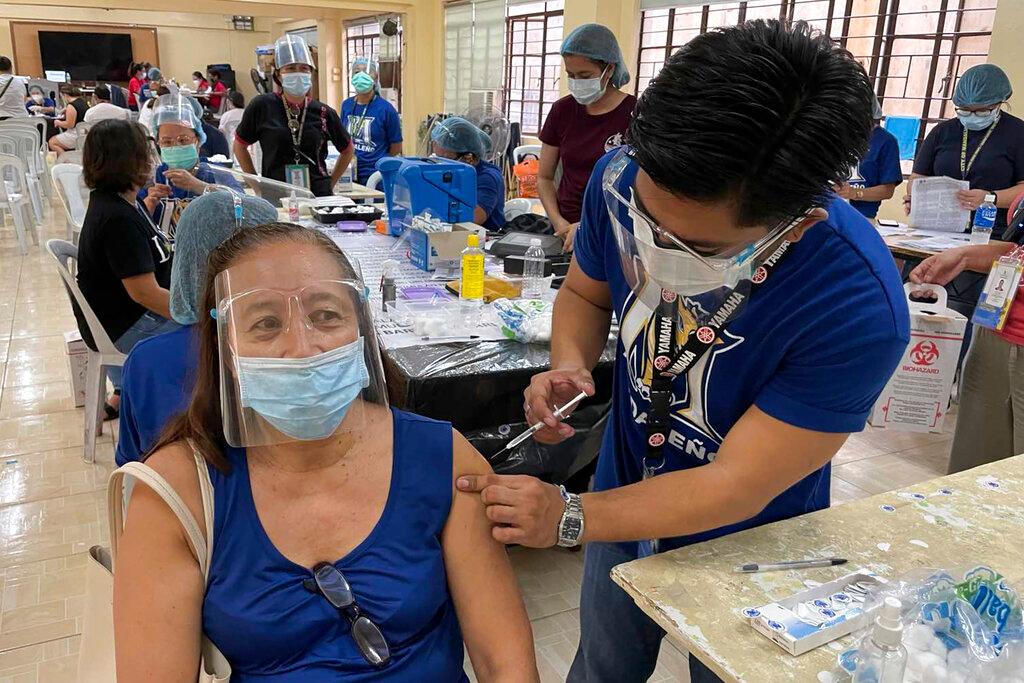 A resident is inoculated with the AstraZeneca Covid-19 vaccine in Mandaluyong city, Philippines, July 23. In recent weeks, daily case rates in the Philippines have hit the highest levels since the start of the pandemic. Photo: AP