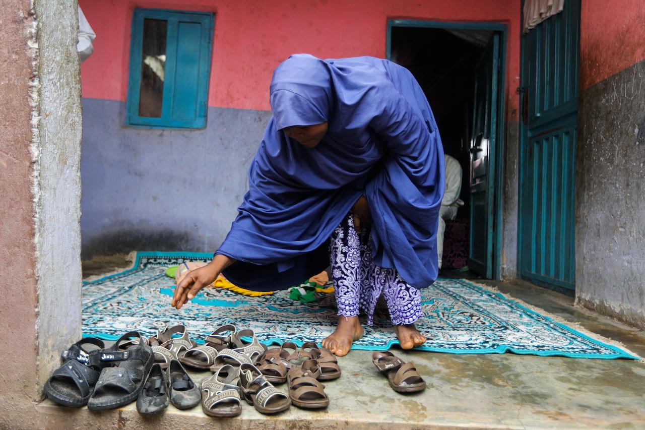 A woman gathers the shoes of seven of her children who were kidnapped by bandits at the Salihu Tanko Islamic school in Tegina, Niger state on Aug 11. Kidnapping for ransom by armed gangs known locally as bandits has become a grim trend in northwest and central Nigeria, with around 1,000 students snatched this year. Photo: Reuters