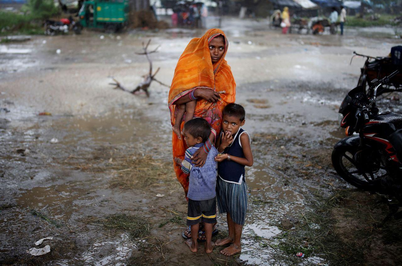 A woman stands with her children as she waits to receive a dose of Covid-19 vaccine during a vaccination drive in New Delhi, India, Aug 31. Photo: Reuters