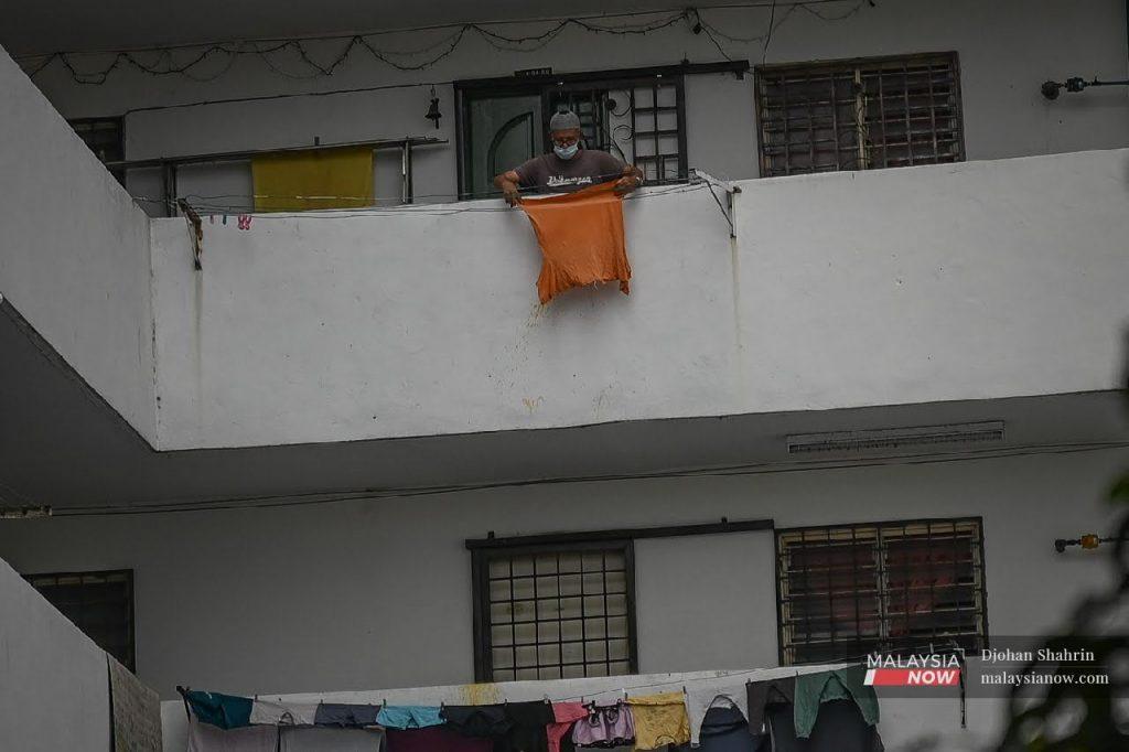 A resident hangs out his laundry at the Pantai Ria People's Housing Project in Kuala Lumpur, which was recently placed under enhanced movement control order due to the spread of Covid-19 infection in the area.
