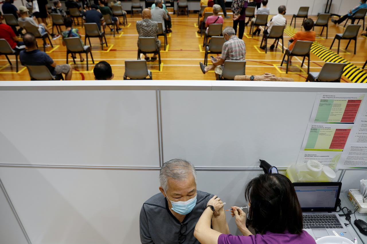 A man receives his vaccination at a Covid-19 vaccination centre in Singapore in this March 8 file photo. Photo: Reuters