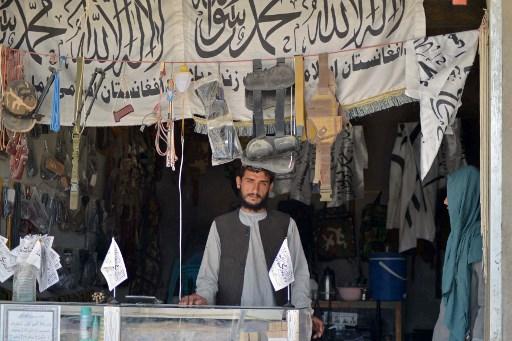 An Afghan vendor selling weapons and ammunition waits for customers in his shop at a market in Panjwai district of Kandahar province on Sept 4. Photo: AFP