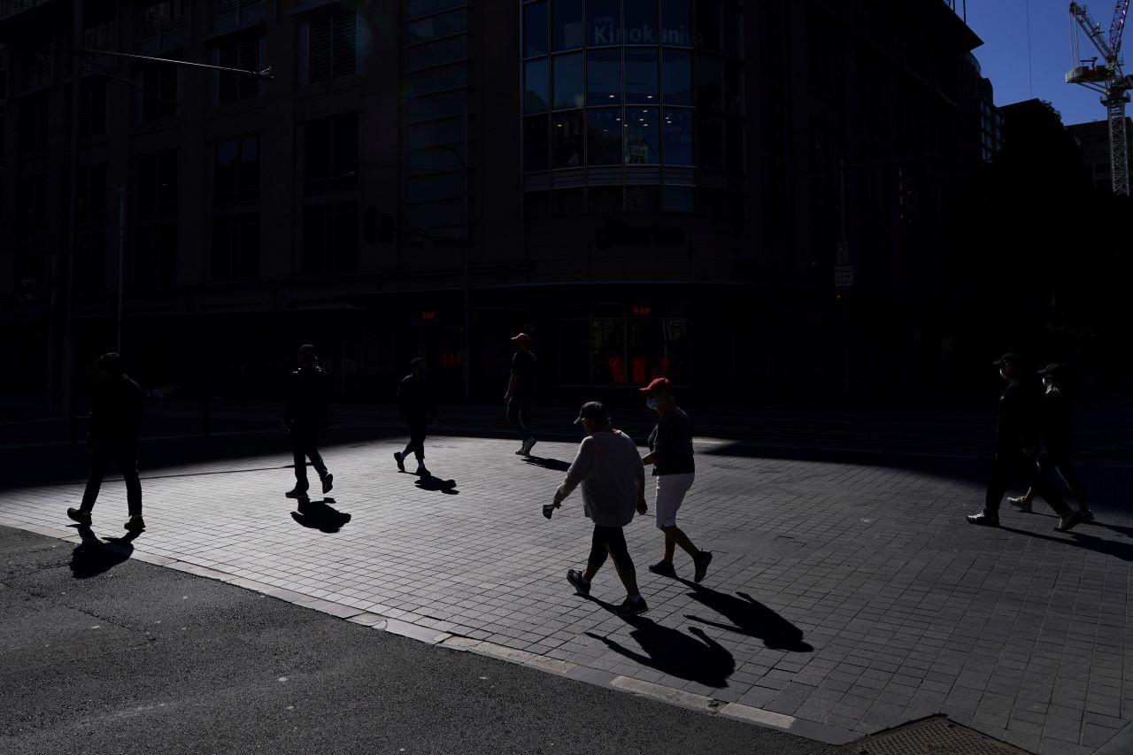 Pedestrians cross a quiet street in the city centre during a lockdown to curb the spread of a Covid-19 outbreak in Sydney, Australia, Sept 7. Photo: Reuters