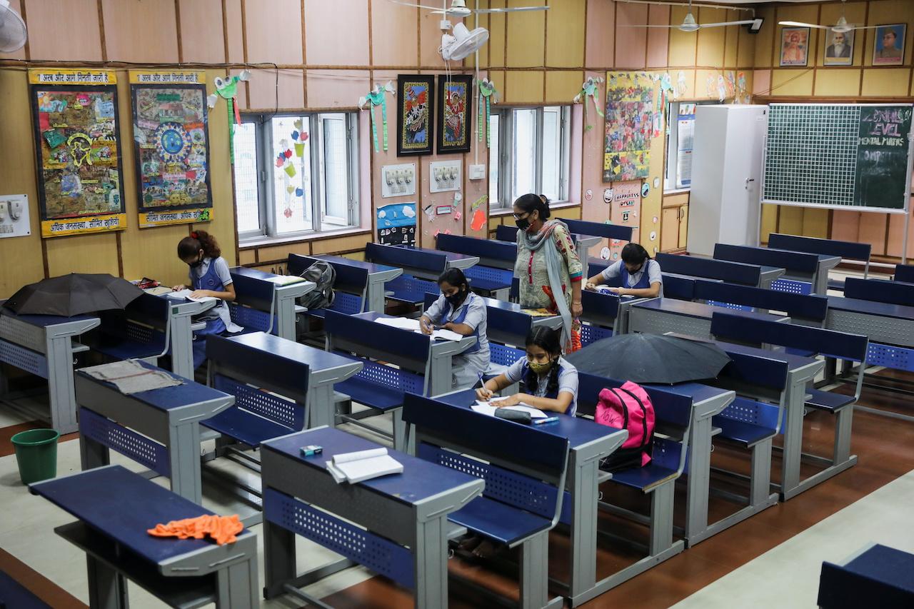 Students do their work in a classroom at a government school in New Delhi, India, after the reopening of some schools, Sept 1. Photo: Reuters