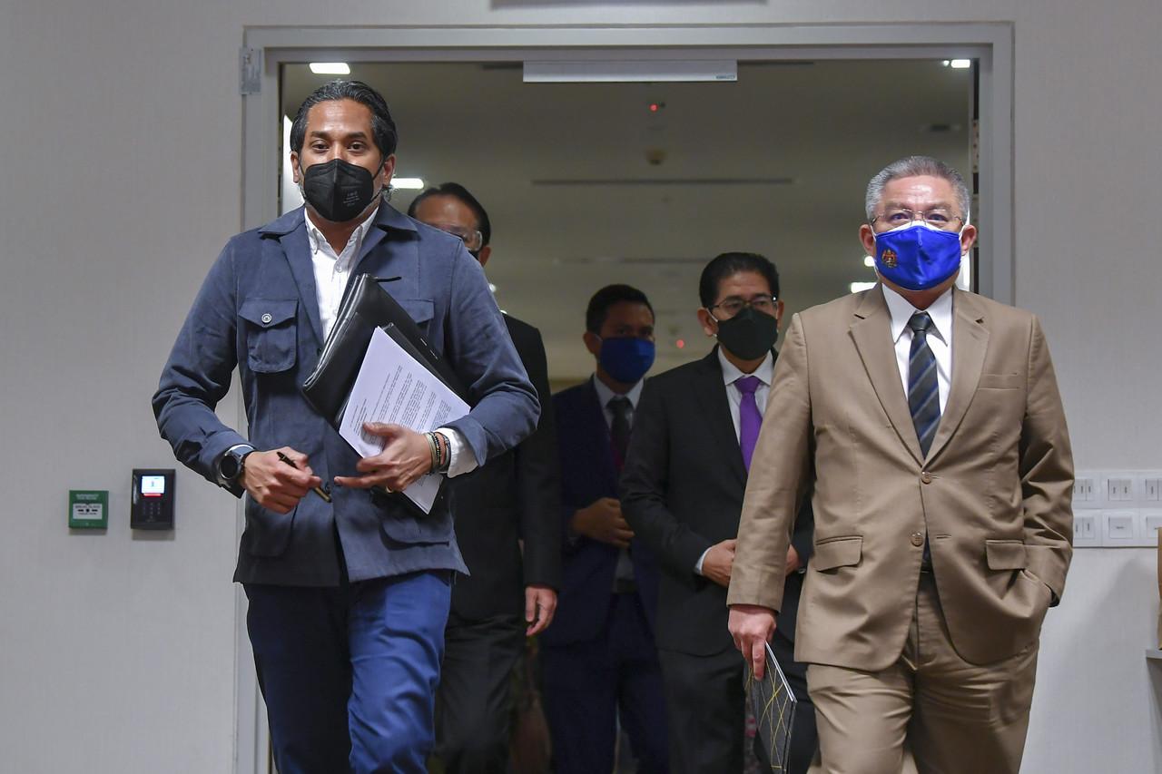 Health Minister Khairy Jamaluddin and Science, Technology and Innovation Minister Dr Adham Baba arrive for a press conference in Putrajaya. Photo: Bernama