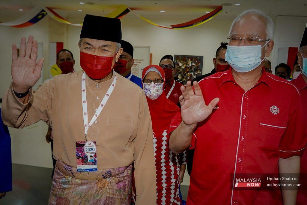 Umno president Ahmad Zahid Hamidi and former prime minister Najib Razak wave upon their arrival at the World Trade Centre in Kuala Lumpur where the party's general assembly was held earlier this year.