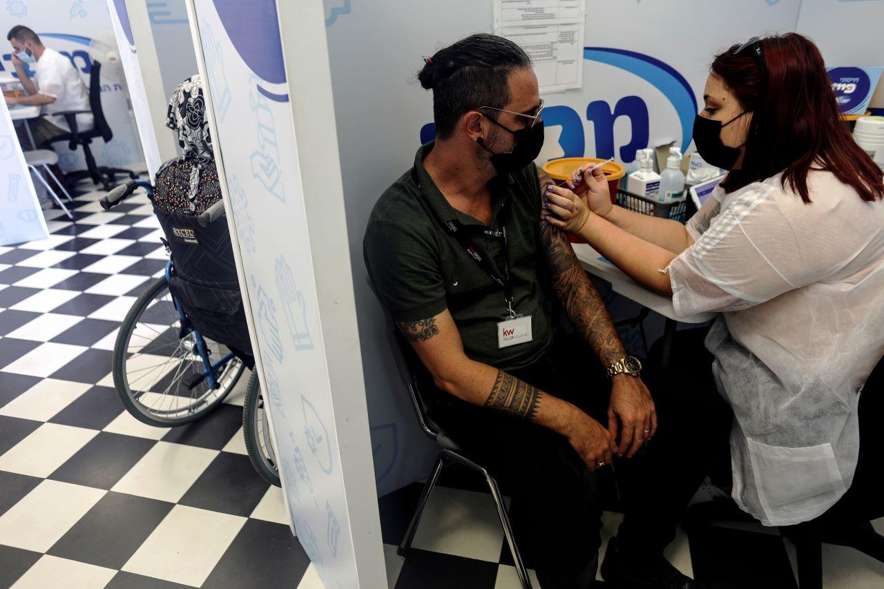 A man receives a third shot of Covid-19 vaccine in Rishon Lezion, Israel, Aug 24. Israel is one of several countries that have started administering booster shots to some of its population. Photo: Reuters
