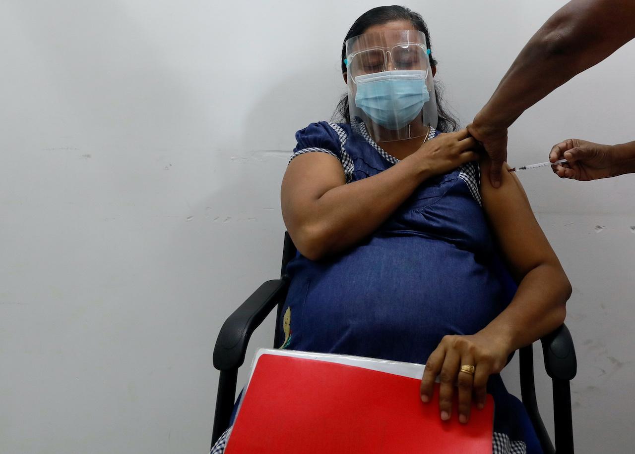 A pregnant woman receives a dose of Covid-19 vaccine during the launching ceremony of vaccination for pregnant women in the country, in Piliyandala suburb, Colombo, Sri Lanka, June 9. Photo: Reuters