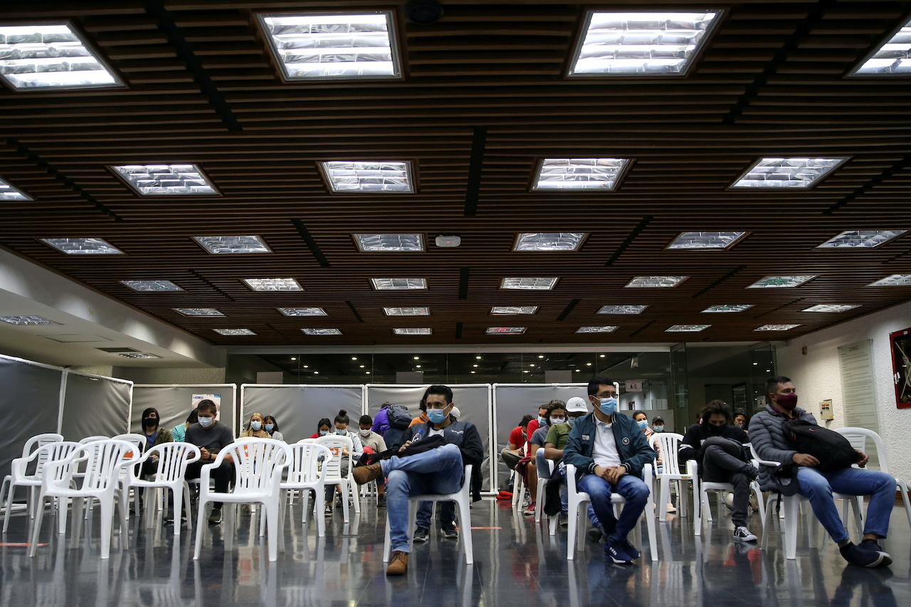 People wait in a recovery room after receiving their first dose of AztraZeneca vaccine against Covid-19 in Bogota, Colombia, Aug 15. Photo: Reuters