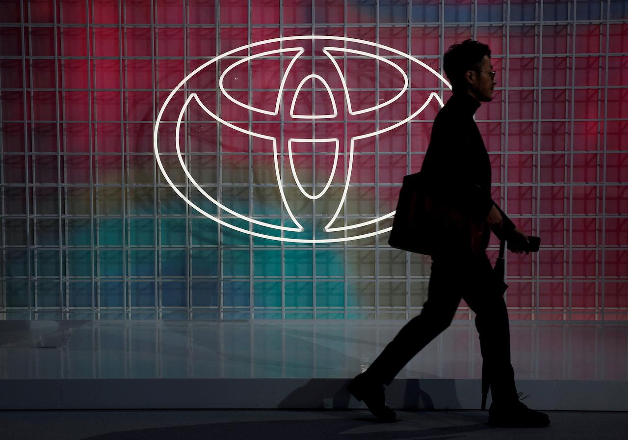 A man walks past a Toyota logo at the Tokyo Motor Show, in Tokyo, Japan, Oct 24. Photo: Reuters