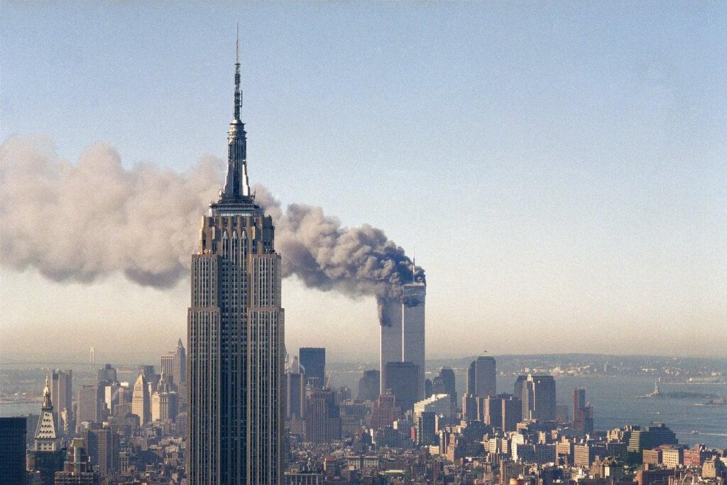 The twin towers of the World Trade Center burn behind the Empire State Building in New York, Sept 11, 2001. Photo: AP