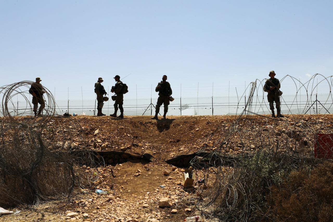 FILE PHOTO: Israeli soldiers guard along a fence leading to the Israeli-occupied West Bank, as part of search efforts to capture six Palestinian men who had escaped from Gilboa prison earlier this week, in northern Israel