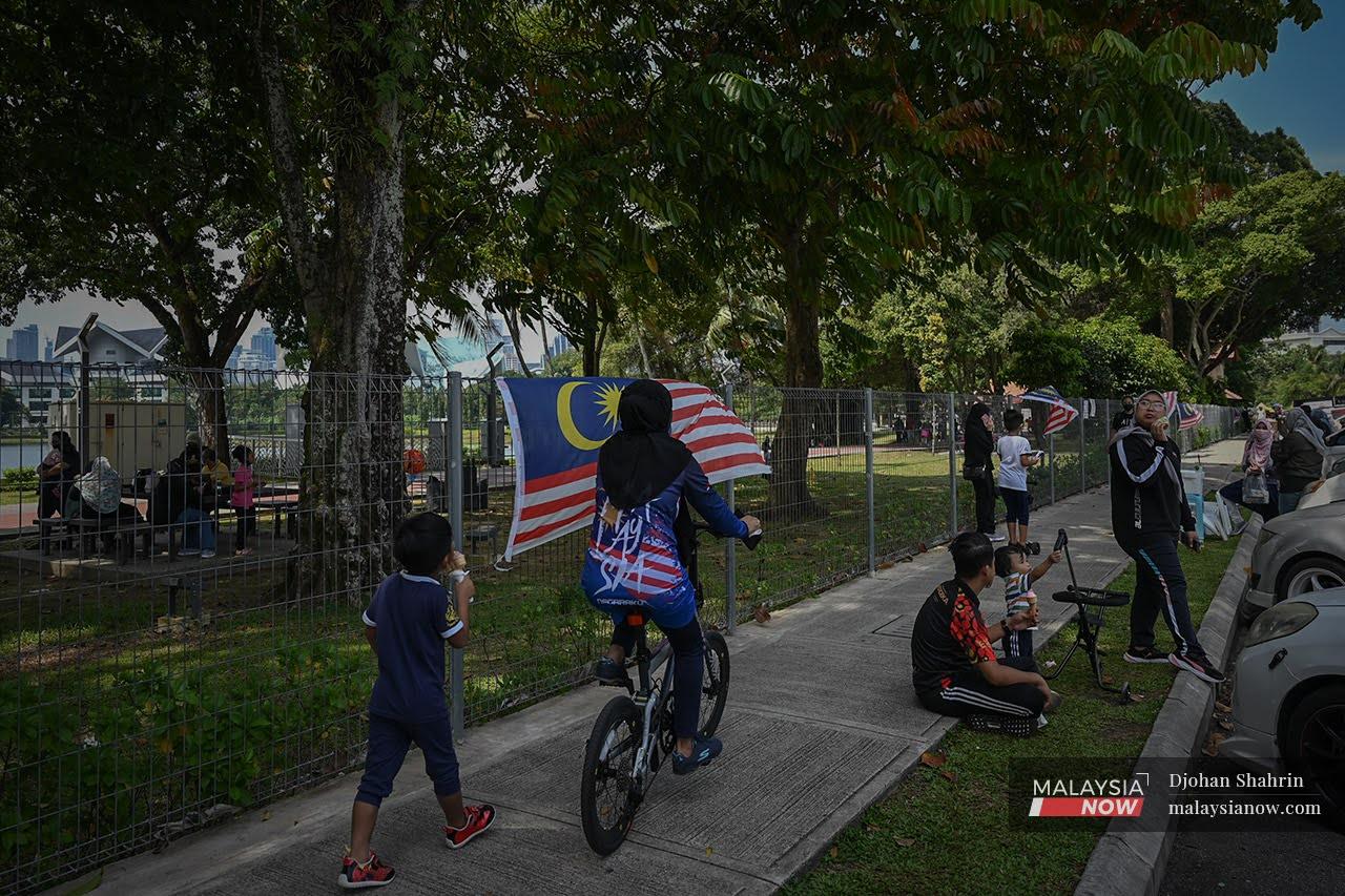 Families cycle through a park in Taman Tasik Titiwangsa, Kuala Lumpur, after the capital city along with Selangor and Putrajaya transitioned to Phase Two of the National Recovery Plan.