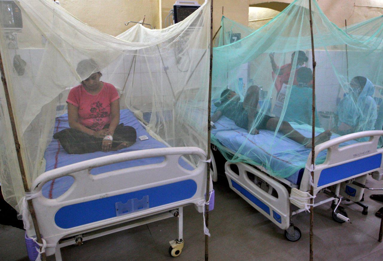 Dengue-infected patients sit under mosquito nets after being hospitalised at Tej Bahadur Sapru Hospital in Prayagraj, in the northern state of Uttar Pradesh, India, Sept 13. Photo: Reuters