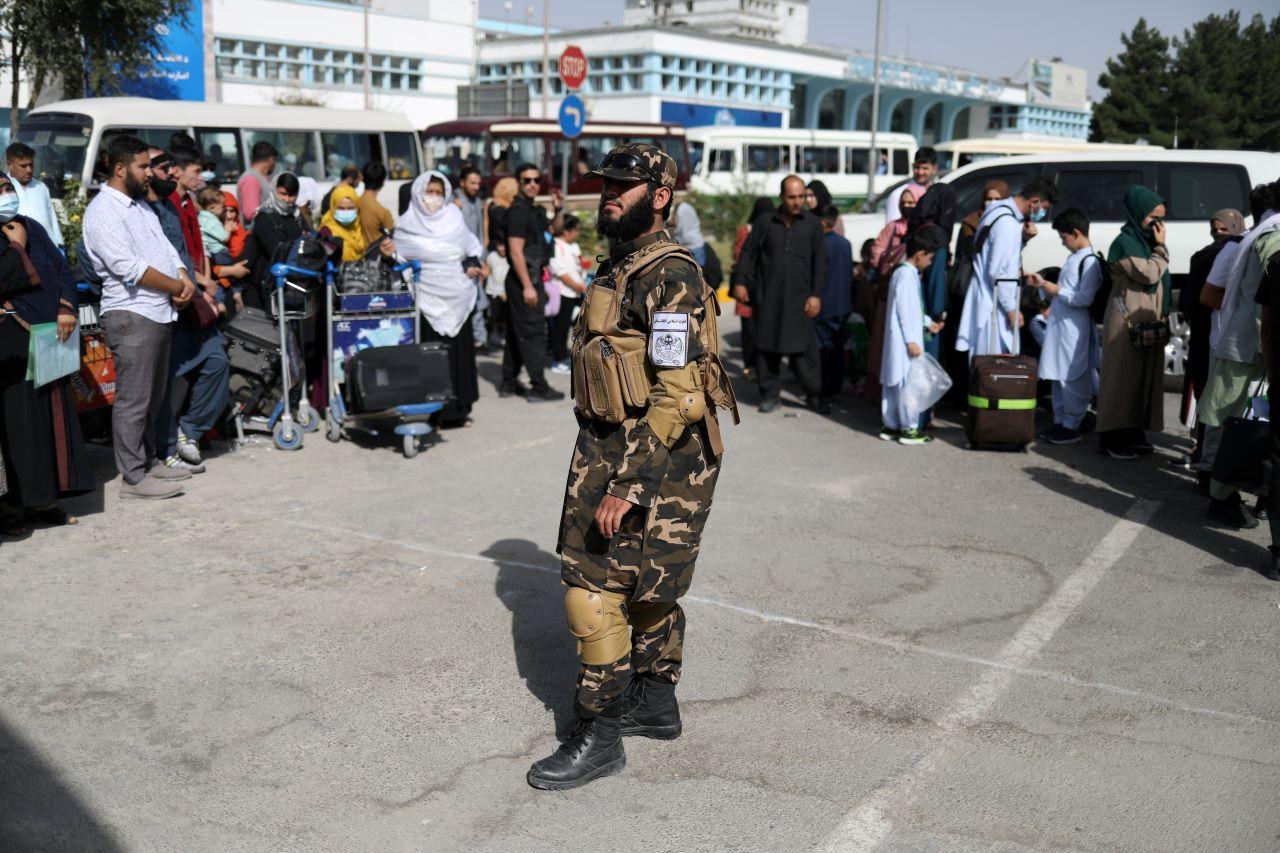 A member of Taliban security forces stands among travellers at the international airport in Kabul, Afghanistan, Sept 10. Photo: Reuters
