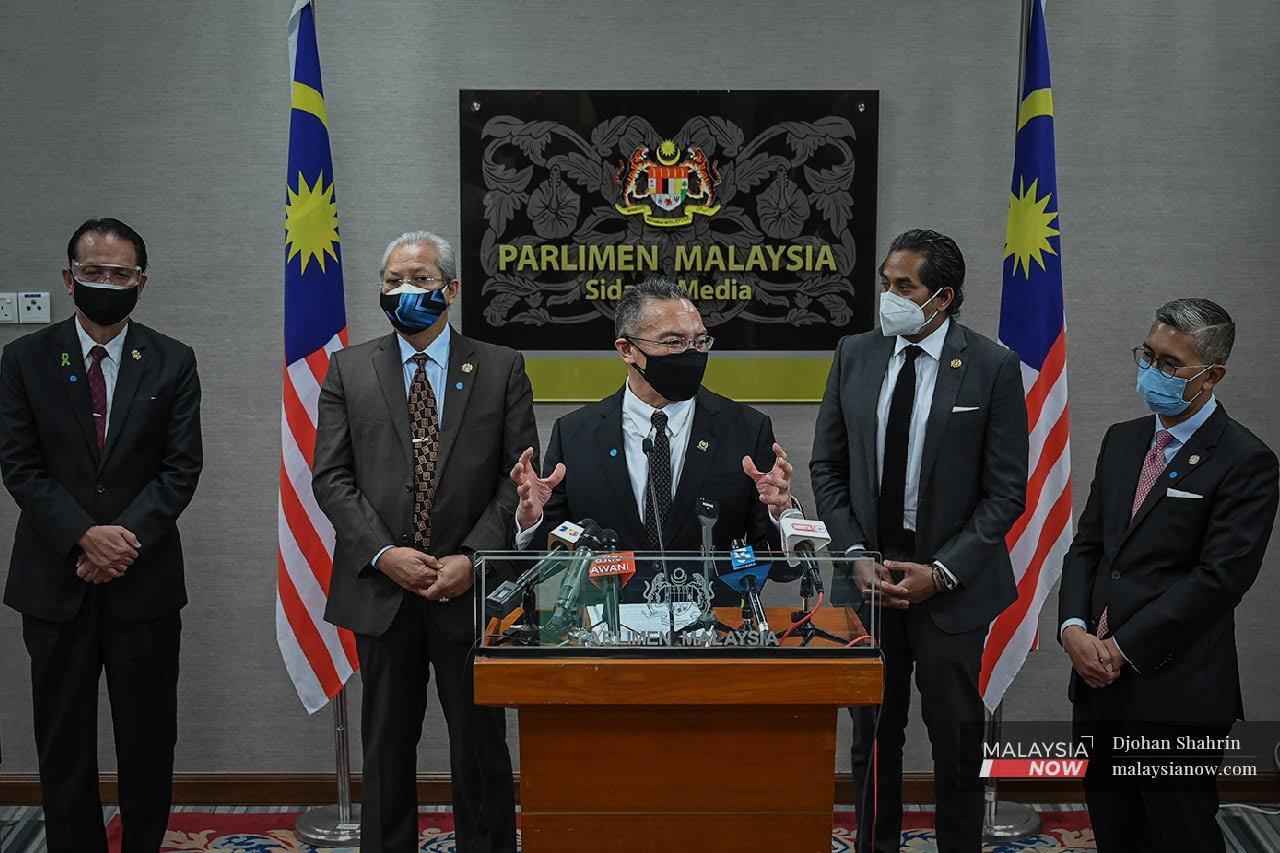 Defence Minister Hishammuddin Hussein speaks at a press conference in Parliament, flanked by (from left) health director-general Dr Noor Hisham Abdullah, Communications and Multimedia Minister Annuar Musa, Health Minister Khairy Jamaluddin and Finance Minister Tengku Zafrul Aziz.