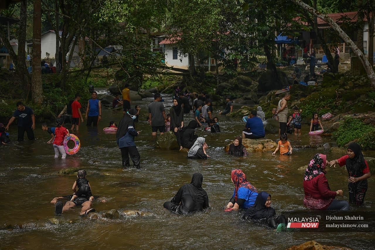 Families spend the weekend at Sungai Congkak in Hulu Langat after the Klang Valley transitioned to Phase Two of the National Recovery Plan.