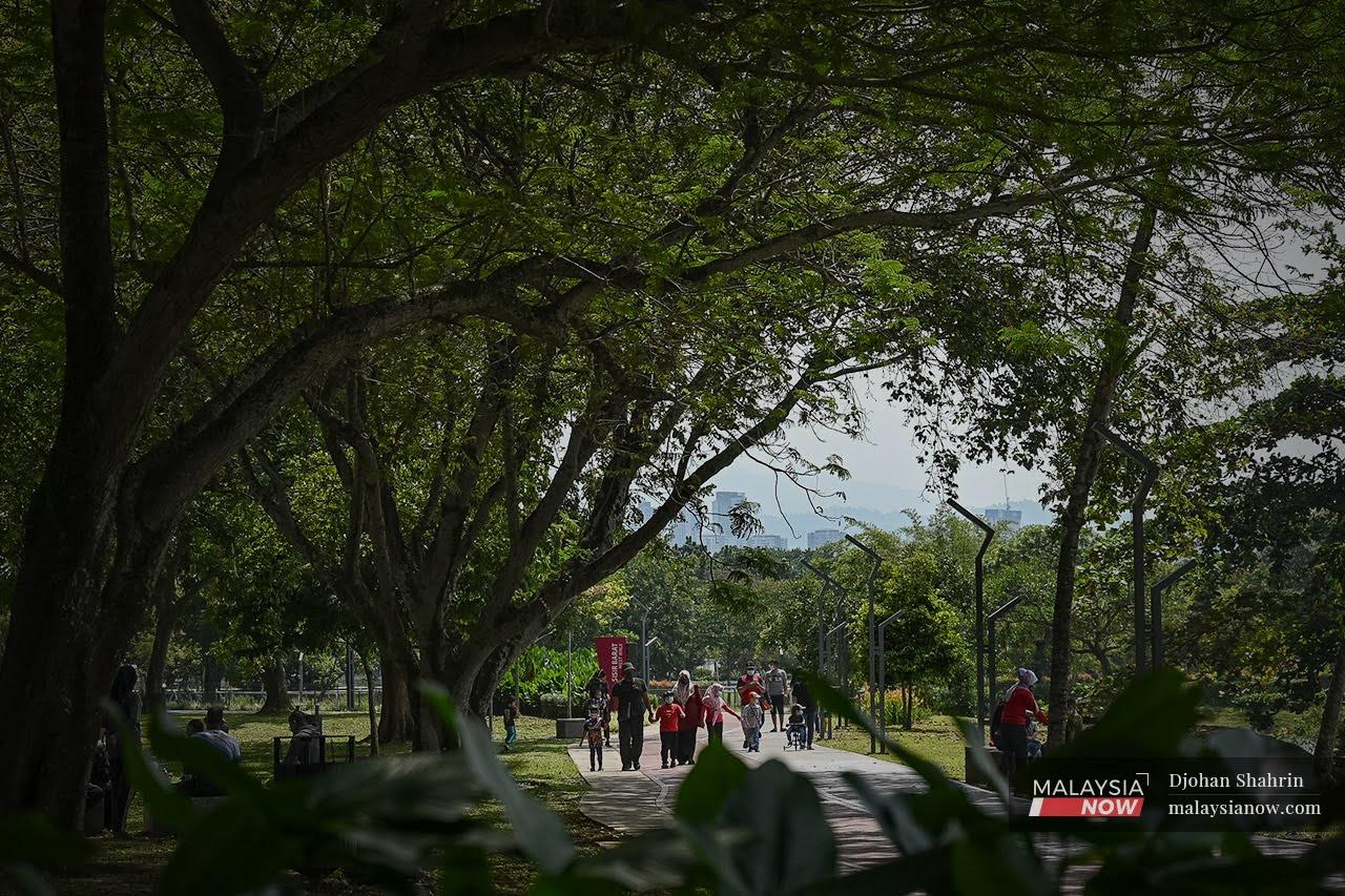 Families stroll through Taman Tasik Titiwangsa in Kuala Lumpur as SOPs are gradually relaxed for the fully vaccinated.