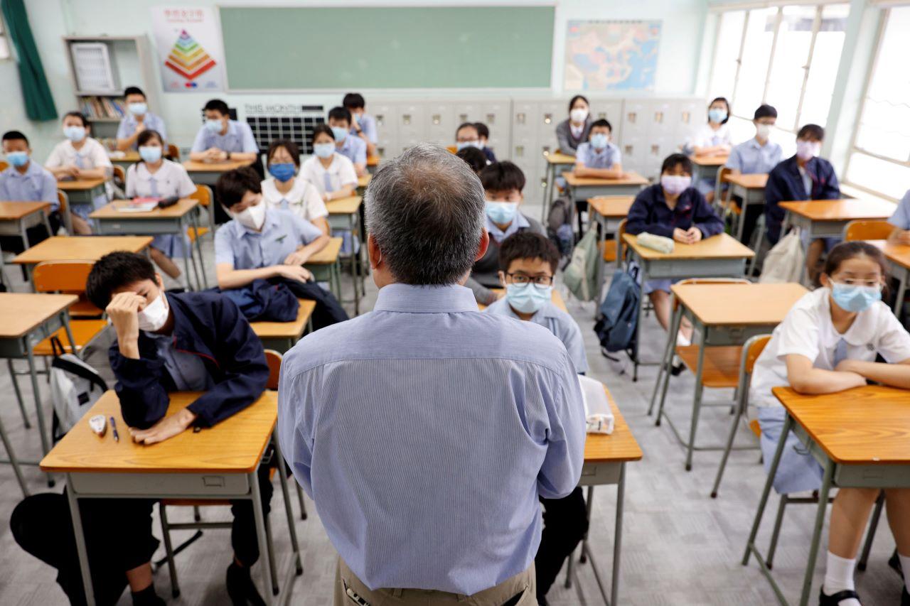 A teacher introduces himself to the students in a classroom at a secondary school, during the first day of the new term, in Hong Kong, Sept 1. Photo: Reuters