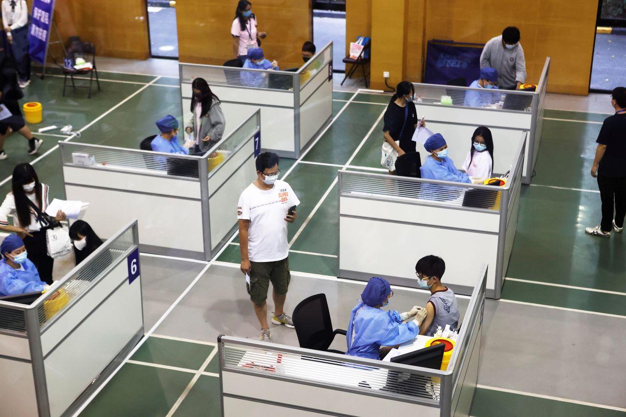 Students receive vaccines against Covid-19 at a vaccination site in Shanghai, China Sept 5. Photo: Reuters
