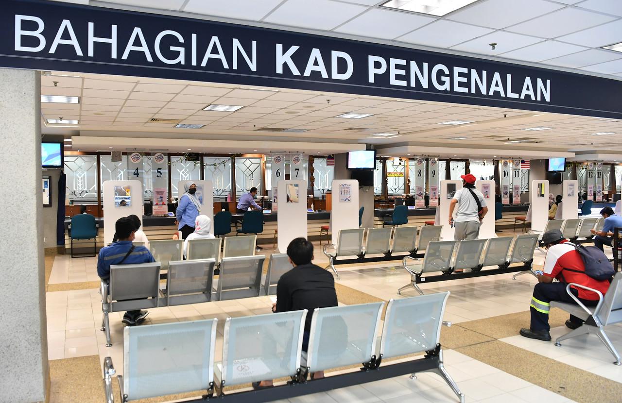 People wait for their turn to be served at the National Registration Department in Putrajaya. Without citizenship, children born overseas to Malaysian mothers are unable to attend public schools or receive government assistance. Photo: Bernama