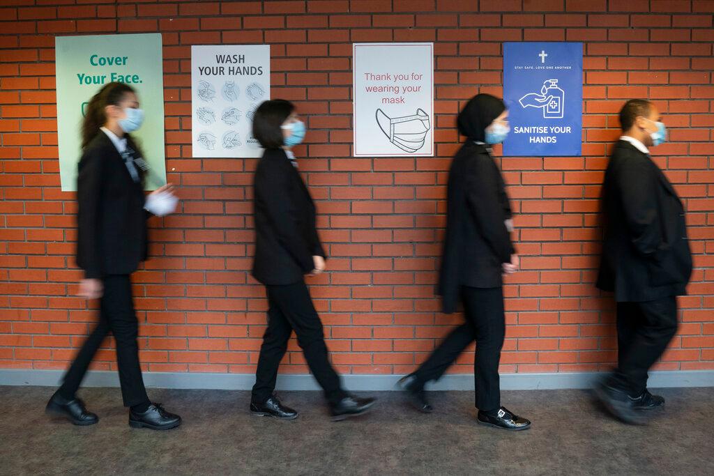 In this March 8 file photo, pupils queue for a socially distanced assembly at a school in in Manchester, England. Photo: AP