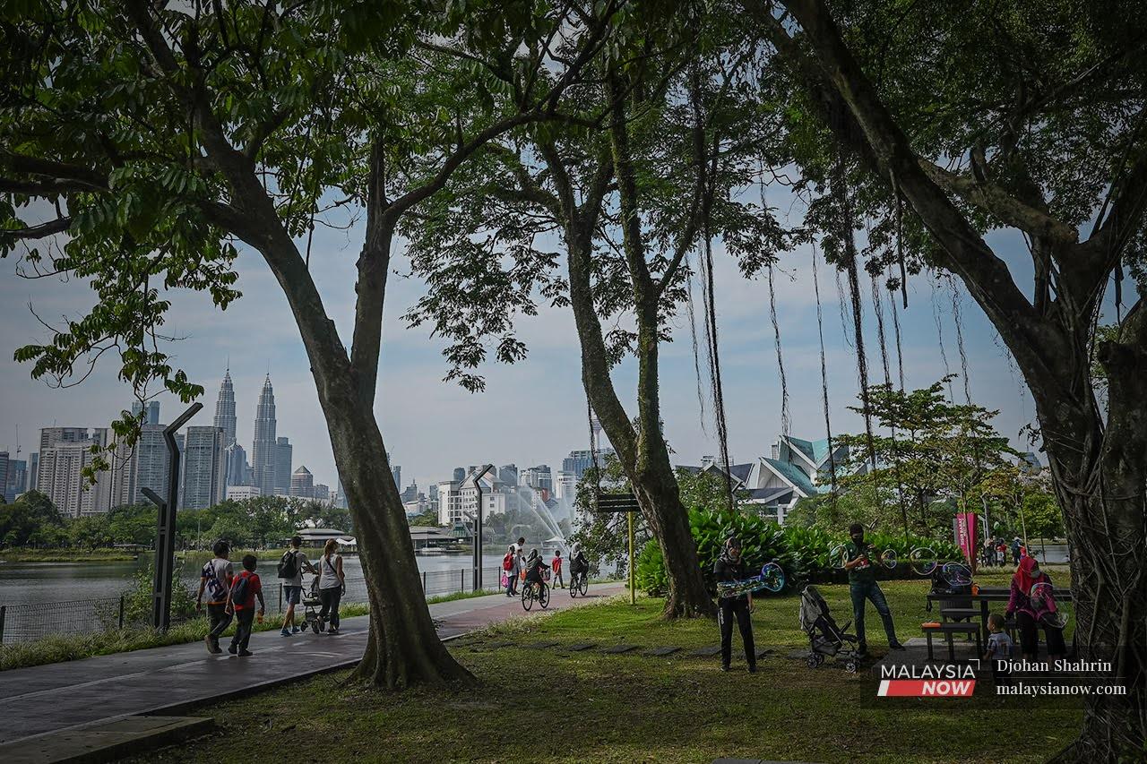 Families enjoy a day at the park at Taman Tasik Titiwangsa in Kuala Lumpur which is now under Phase Two of the National Recovery Plan.