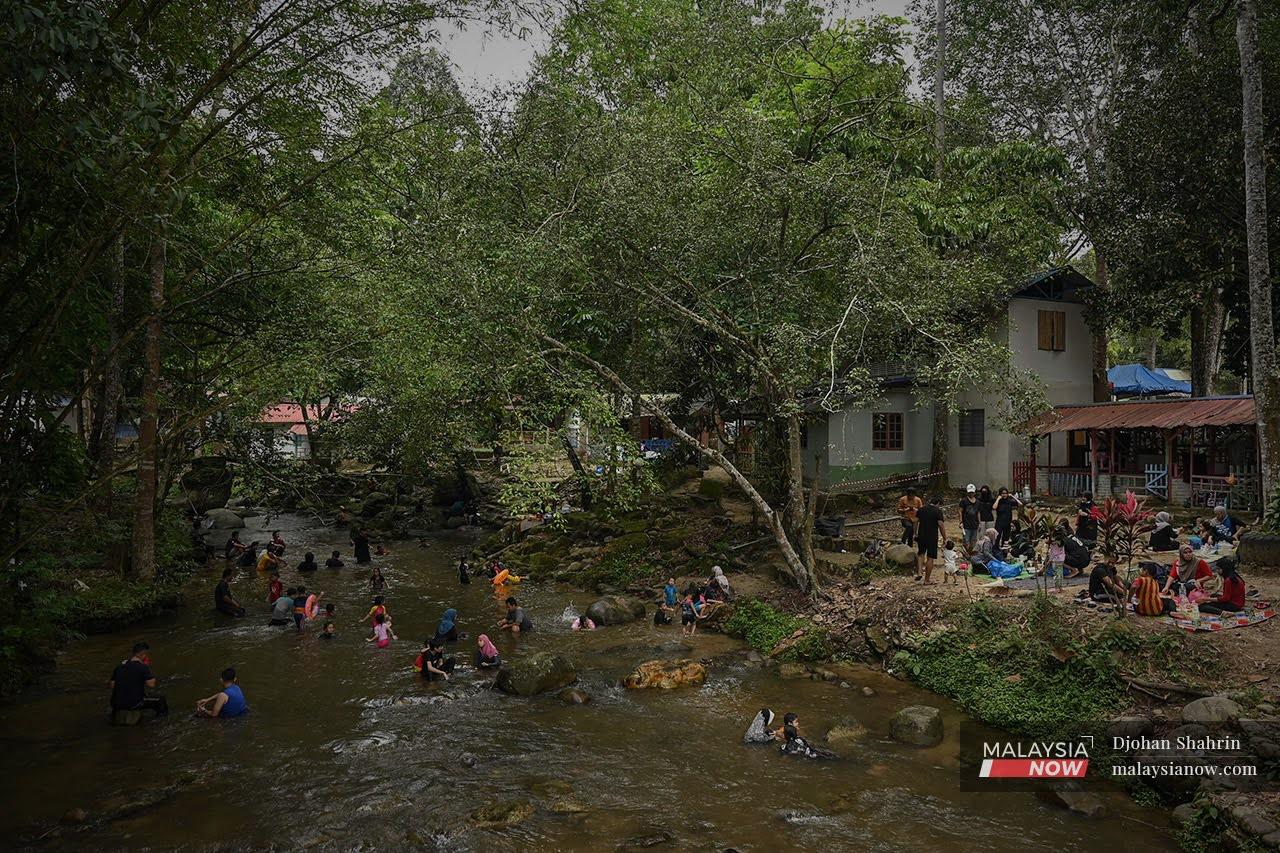 Families flock to a popular vacation spot at Sungai Congkak, Hulu Langat, over the weekend in this photo taken on Sept 12. Authorities have reminded those headed for recreational areas to continue complying with health SOPs.