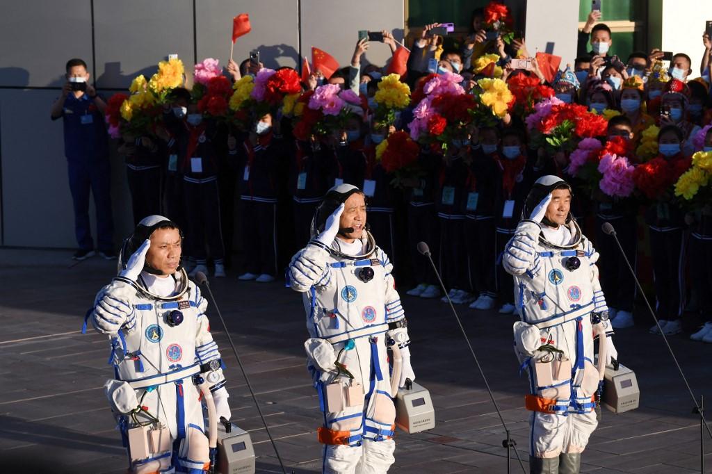 This file photo taken on June 17 shows astronauts Nie Haisheng (centre), Liu Boming (right) and Tang Hongbo saluting during a departure ceremony before boarding the Shenzhou-12 spacecraft on a Long March-2F carrier rocket at the Jiuquan Satellite Launch Centre in the Gobi desert in northwest China. Photo: AFP