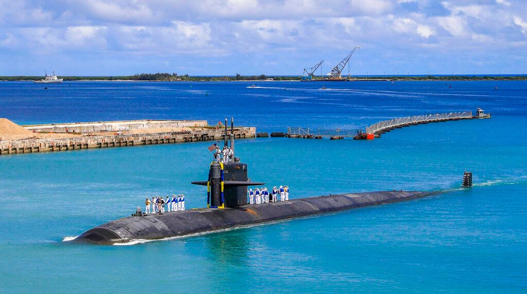 In this photo provided by the US Navy, sailors stand atop the Los Angeles-class fast attack submarine USS Oklahoma City as it returns to the US naval base in Guam on Aug 19. Australia is only the second country after Britain with which the US has shared its nuclear technology for submarines. Photo: AP