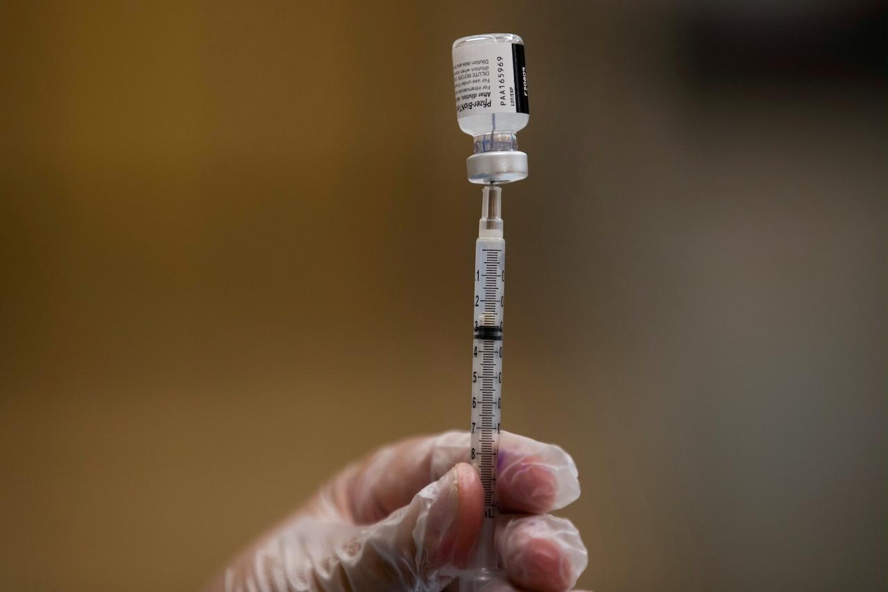 A nurse fills a syringe with Pfizer vaccine as mobile vaccination teams begin visiting schools to deliver first and second doses vaccines in Los Angeles, California, Aug 30. Photo: Reuters