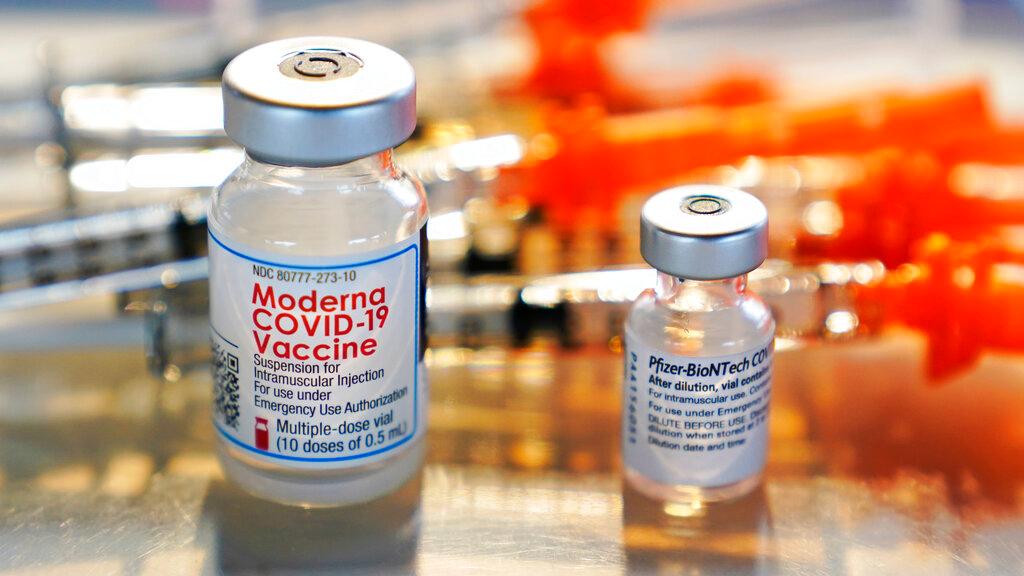 In this Feb 25, file photo, vials for the Moderna and Pfizer Covid-19 vaccines are displayed on a tray at a clinic in New Hampshire. Photo: AP