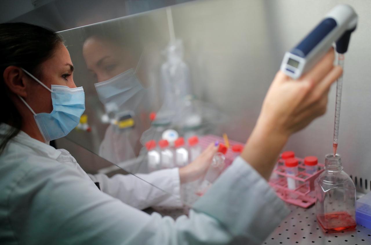 A researcher works on cell culture in a laboratory as part of a project to develop a Covid nasal spray vaccine that could protect against the disease, at the University of Tours, France, Sept 15. Photo: Reuters