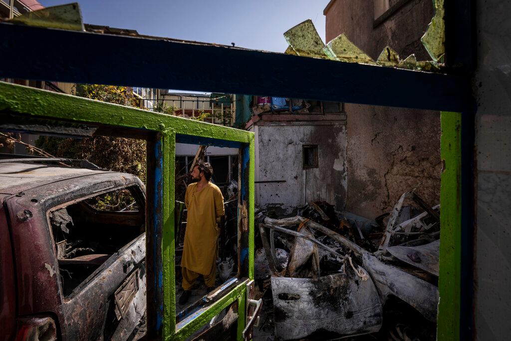 A man inspects the damage to the family home of Ezmarai Ahmadi, where an errant US drone strike killed 10 people including seven children. Photo: AP
