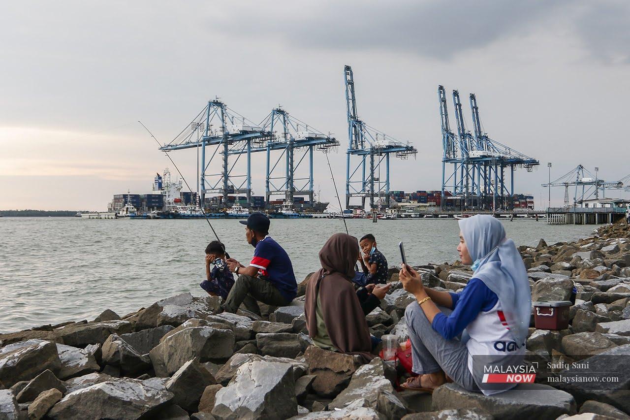 A family spends their evening fishing at Tanjung Harapan in Klang as health restrictions are gradually eased for the fully vaccinated.