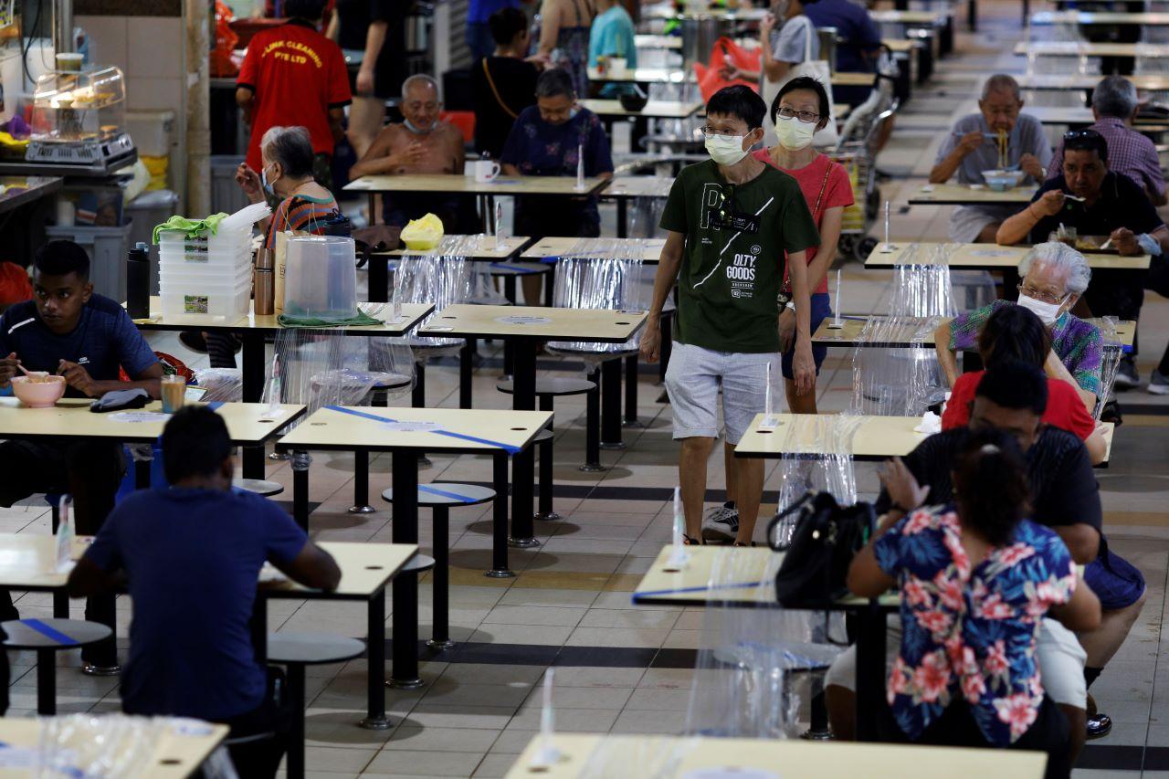 People eat at a hawker centre during the Covid-19 outbreak, in Singapore Sept 21. Photo: Reuters