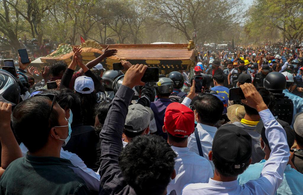 A crowd gathers as a hearse carrying the body of a young protester arrives at a cemetery in Mandalay, Myanmar, in this March 4 file photo. Myanmar has been in turmoil since a government led by pro-democracy veteran Aung San Suu Kyi was toppled on Feb 1, sparking nationwide anger, strikes and protests. Photo: AP