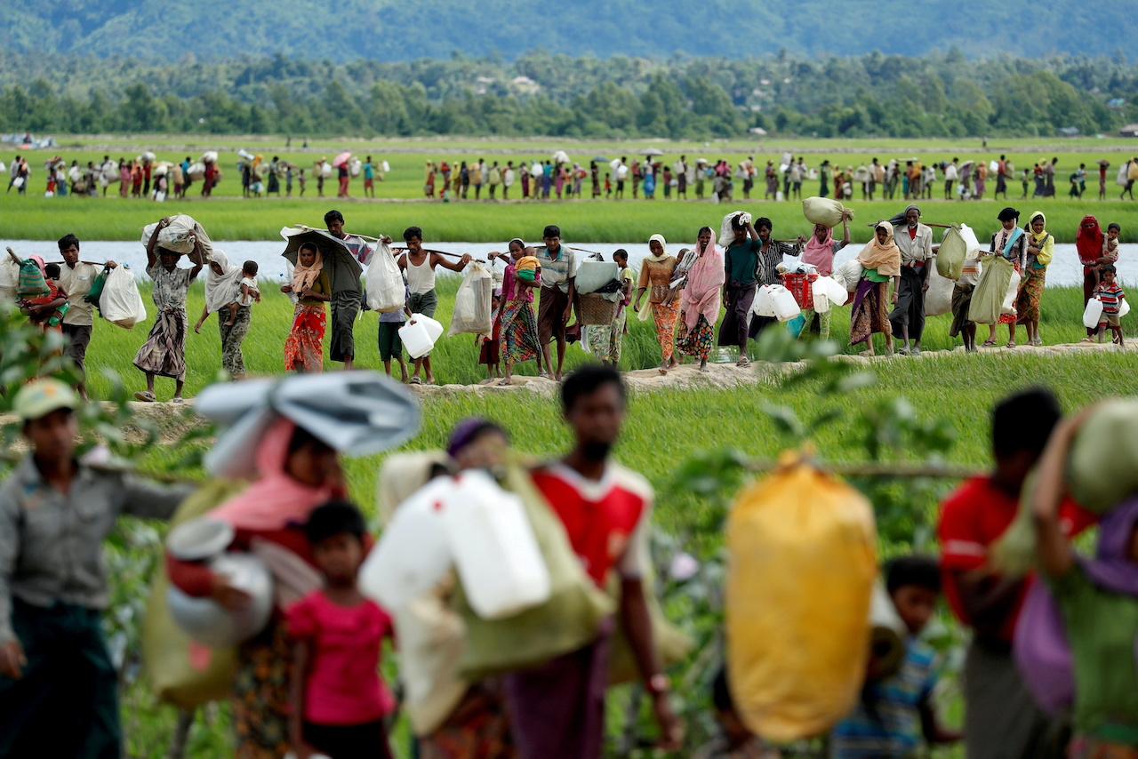 Rohingya refugees who crossed the border from Myanmar walk after receiving permission from the Bangladeshi army to continue on to the refugee camps in Palang Khali, near Cox's Bazar, Bangladesh, in this Oct 19, 2017 file photo. Photo: Reuters