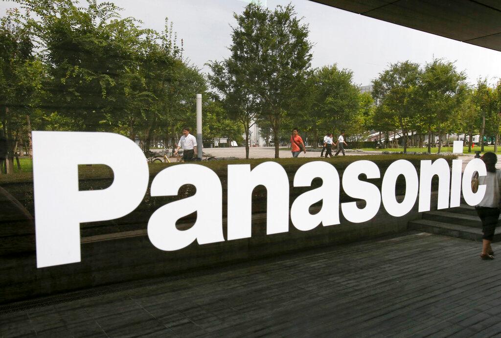 Pedestrians are reflected in the glass window of a Panasonic showroom in Tokyo, Japan. Panasonic is closing down its compressor manufacturing operations in Singapore due to the 'challenging business outlook'. Photo: AP