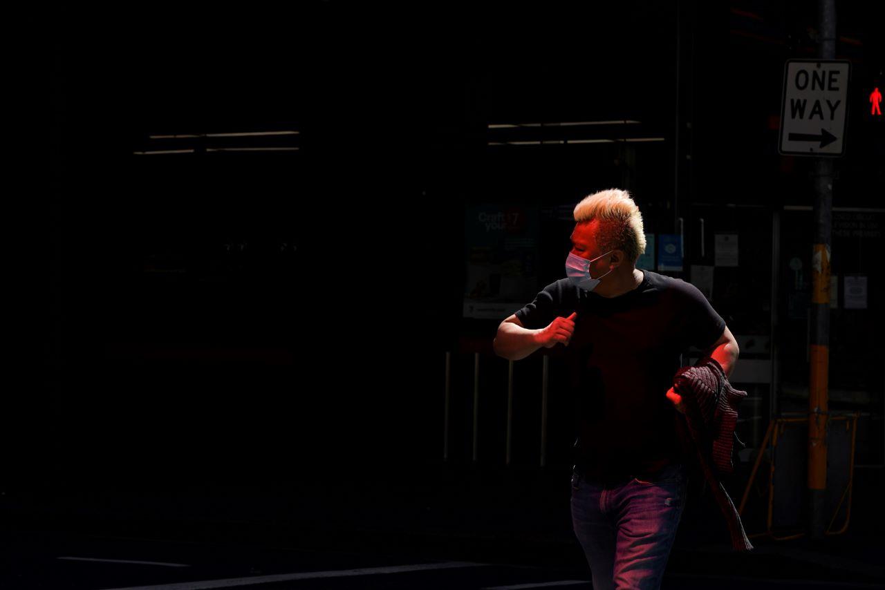 A pedestrian wearing a protective face mask crosses an intersection in the city centre during a lockdown to curb the spread of a Covid-19 outbreak in Sydney, Australia, Sept 24. Photo: Reuters