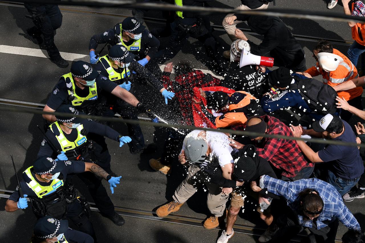 Victoria police clash with protesters during a demonstration in Melbourne, Australia, Sept 18. Photo: Reuters